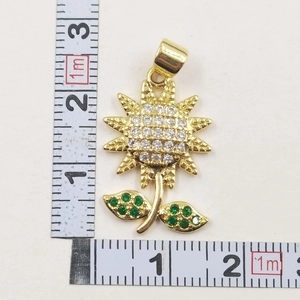 Macro shot of sunflower pendant with white crystals and ruler showing 2.2cm width
