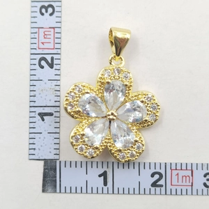Detailed view of sunflower pendant diameter showing 2cm size on measuring tape