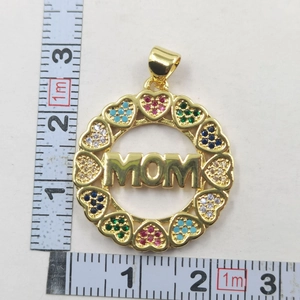 Macro shot of 3cm round MOM pendant with colorful zircon hearts and ruler measurement