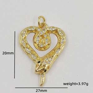 Macro detail of gold snake heart pendant with zircon pavé showing 20mm by 27mm dimensions