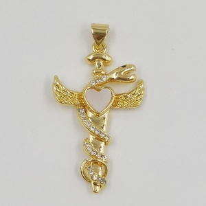 Golden snake pendant with wings and white heart inlay on a white textured background