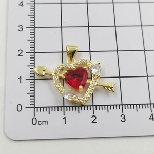 Macro view of Cupid heart pendant size showing 2.5cm width on measurement scale