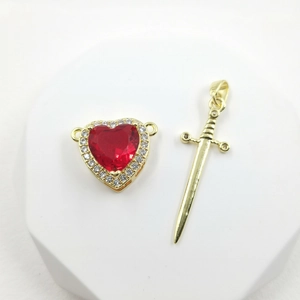 Micro-paved gold heart and arrow couple necklaces displayed on minimalist podiums