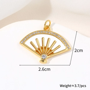 Detailed view of gold fan-shaped pendant with white shell inlay and zircon accents
