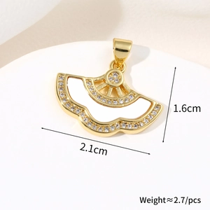 Macro shot showing dimensions of a gold fan-shaped pendant with white cubic zirconia crystals