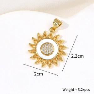 Close-up of a 2cm x 2.3cm golden sun pendant with white enamel and sparkling zircon