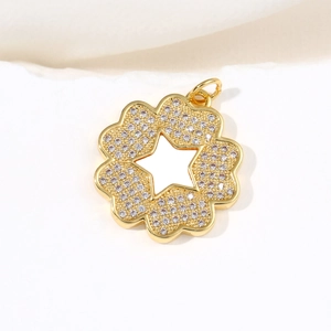 Golden flower pendant with shell petals and star cutout on a minimalist background
