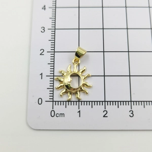 Detailed size measurement of a gold sun and moon pendant on a metric scale ruler