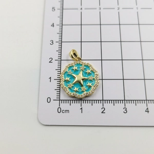 Detailed view of sun star pendant with blue enamel and crystal halo on size scale