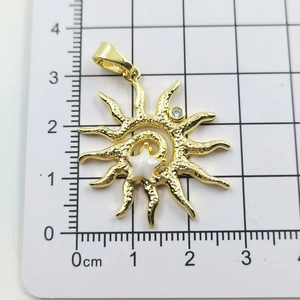 Detail of sunflower pendant with hammered gold texture and star-shaped mother of pearl inlay