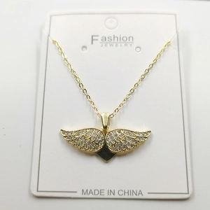 Golden necklace featuring a crystal-pave angel wing pendant on a jewelry display card