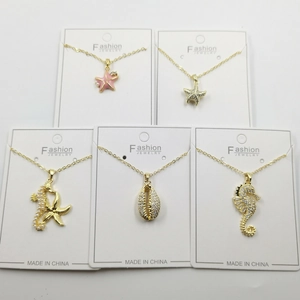 Five gold necklaces featuring seahorse and starfish pendants with zircons and enamel details