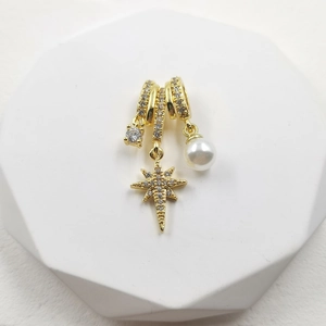Gold pendant set with North Star zircon, pearl and single diamond on minimalist stand