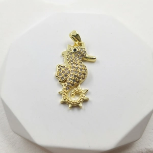 Elegant gold seahorse pendant necklace with sparkling white zircons and black gem eye