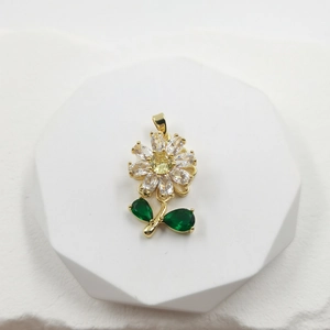 Exquisite rose flower pendant with yellow zircon and green leaf on white pedestal