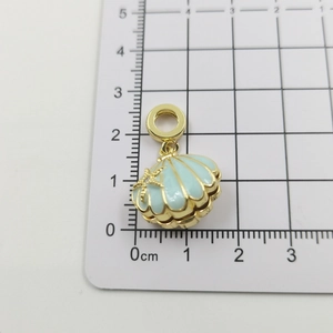 Detail of light blue shell pendant with gold starfish and 18k gold plating charm