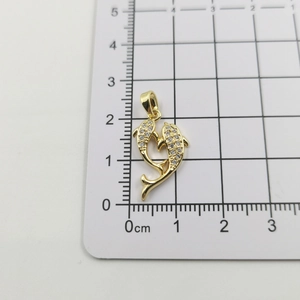 Macro detail of 18k gold dolphin heart pendant with zircon inlay showing 1.8cm height