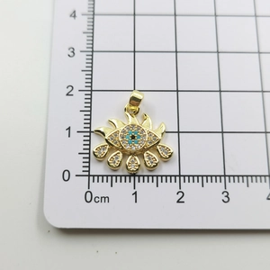 Detail view of 18mm evil eye pendant with blue zircon and sunburst gold design