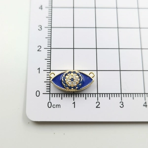 Detailed view of blue enamel evil eye pendant with gold plating and cubic zirconia