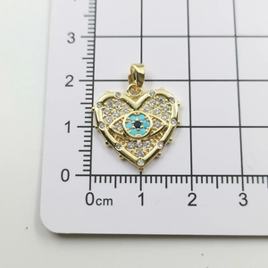Macro detail of evil eye heart pendant with dimensions showing 1.8cm scale size
