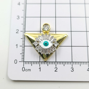 Detailed view of evil eye gold pendant showing dimensions on a white measurement scale