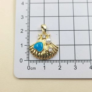 Macro shot of seashell pendant with blue heart and pearl showing 2.8cm height dimensions
