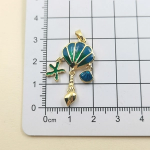 Detail view of colorful shell pendant with scale showing size of marine necklace charm