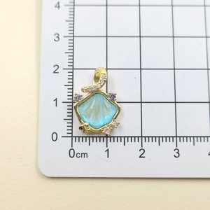 Detailed scale view showing the light blue shell pendant with zircon embellishments