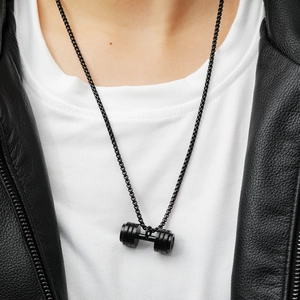 Men's black dumbbell pendant necklace with black box chain on leather jacket