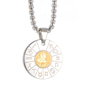 Macro shot of silver and gold stainless steel Leo zodiac pendant with engraved symbols