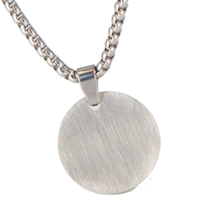 Close-up of circular brushed stainless steel pendant with matching silver box chain