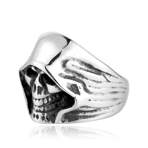 Detailed side view of vintage silver steel skull ring with hooded reaper design