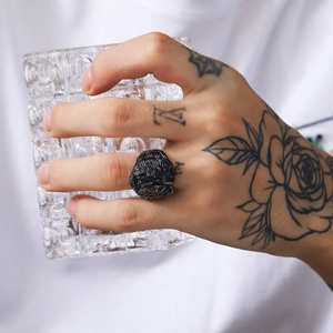 Detailed close-up of a men's vintage black lion head ring with punk style relief