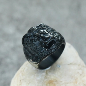 Detailed macro shot of vintage black lion head ring on stone, punk style men's jewelry