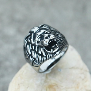 Detailed close-up of a punk-style lion head ring with vintage stainless steel finish