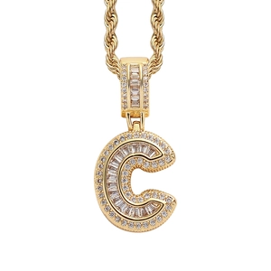 Detail of hip hop letter C pendant with sparkling pave set zircons on rope chain