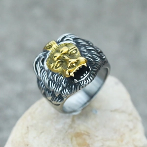 Macro shot of punk lion head ring featuring gold polish and vintage silver finish