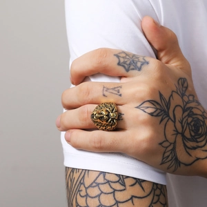Macro detail of men's vintage gold lion head ring with intricate 3D carved textures