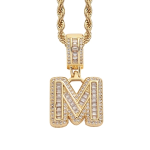 Macro shot of gold letter M pendant with paved clear stones on a thick rope chain