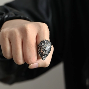 Detailed close-up of a punk rock lion head ring with vintage silver finish on finger
