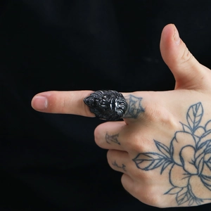 Detailed close-up of a bold black matte lion head ring featuring rock punk style design