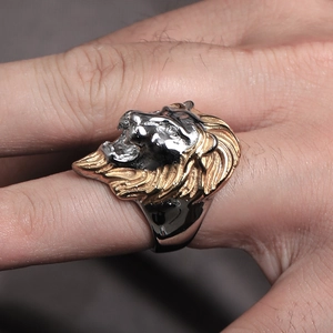 Macro shot of men's lion head ring with dual-tone gold and black metallic finish