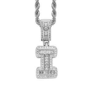Close-up of silver-tone letter I pendant with baguette-cut zircons on twist chain