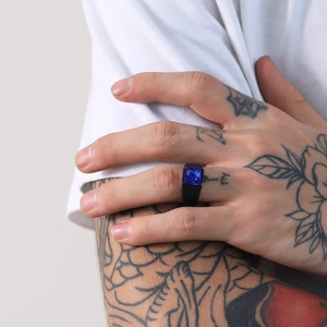 Vista detallada de un anillo de sello negro para hombre con piedra azul cuadrada y grabado