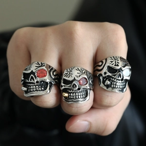 Punk rocker skull ring set in vintage silver finish with red ruby eye accents