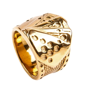 Macro shot of gold poker card ring featuring detailed royal flush engraving and knurled edges