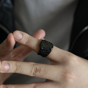 Detailed view of punk style poker royal flush ring with embossed vintage patterns