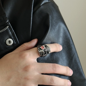 Detail of punk style skull ring with red gemstone eye and vintage steel finish