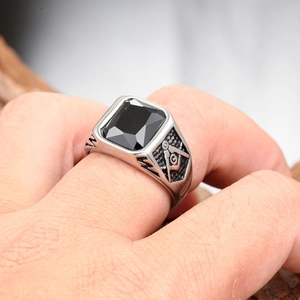 Close-up of Masonic compass and square symbol on silver stainless steel ring with black stone
