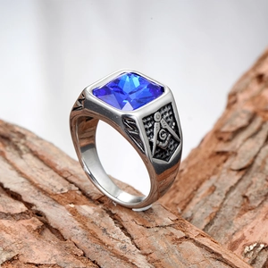 Detail of Masonic ring with a large square blue faceted stone and engraved symbols